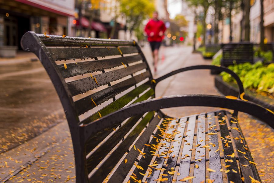 Beloit, WI - Rain Covered Bench on a Street in Wisconsin